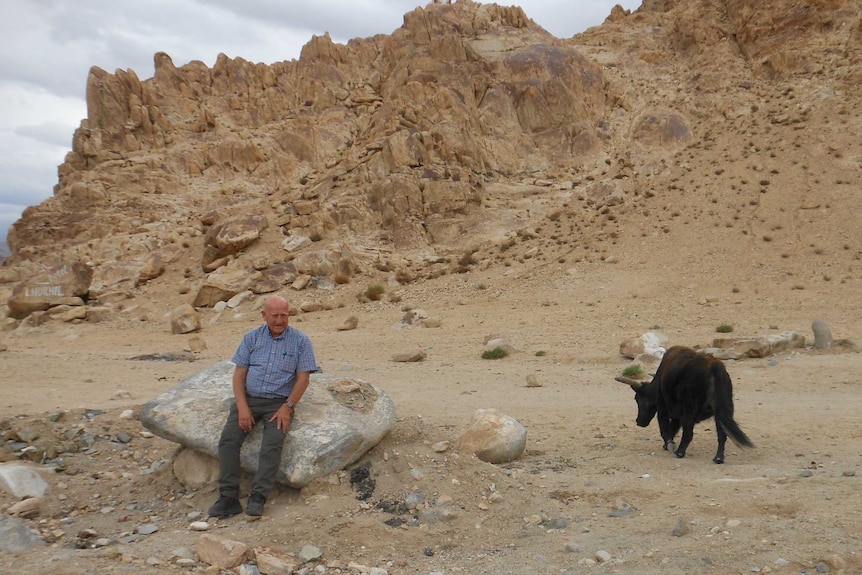 Dr David Gray posing with an injured yak