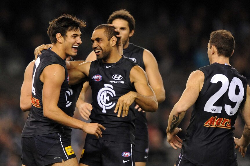 Carlton's Troy Menzel (L) is congratulated after kicking a goal against GWS at Docklands.