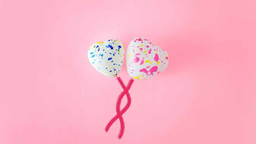 Two heart balloons sit on a pink background to depict settling for an average connection in a romantic relationship.