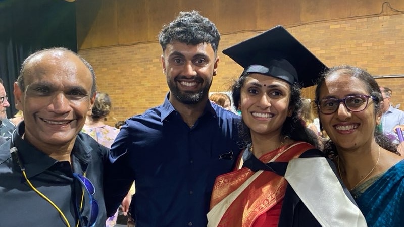 An image of the Warrier family at a graduation ceremony