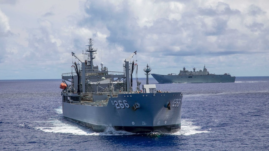An Australian warship in the open ocean with another one behind it.