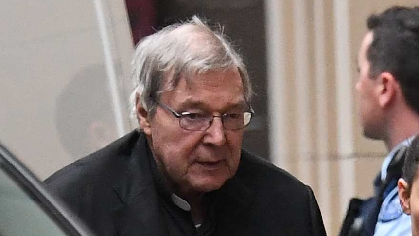 George Pell is escorted by prison guards from a van outside the Supreme Court building.