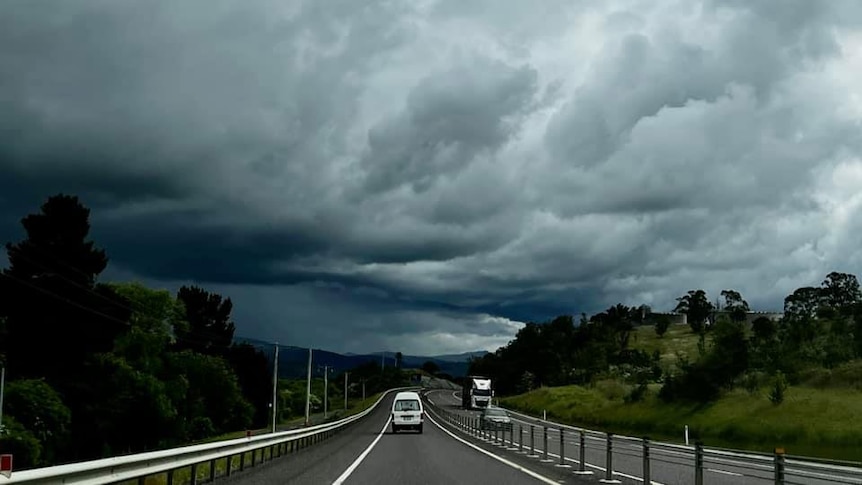 Dark storm clouds over road