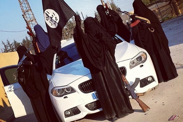 Women wearing burquas pose on a white BMW with machine guns.