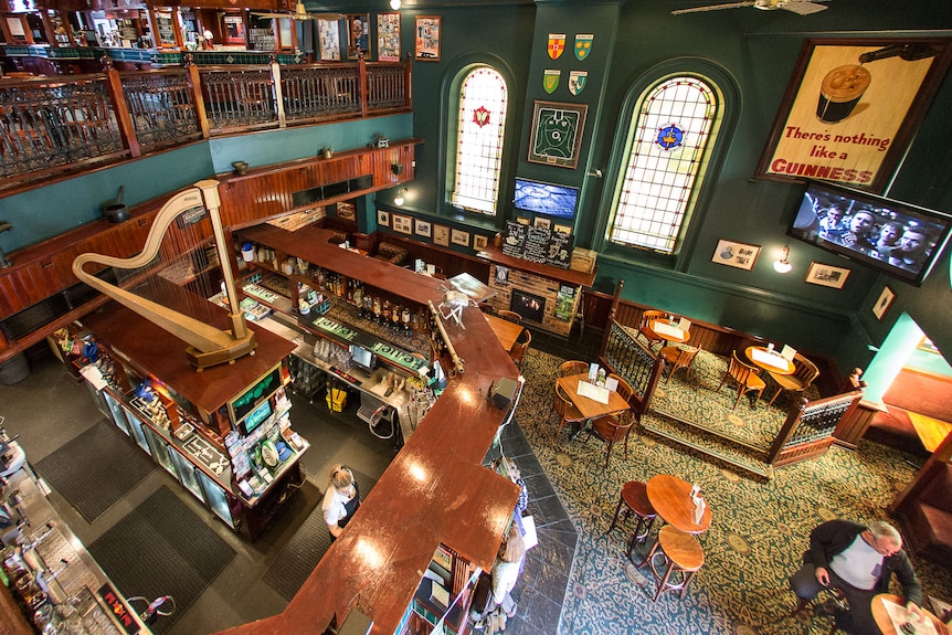 An overhead photo of the inside of an Irish pub, with stained glass church windows.