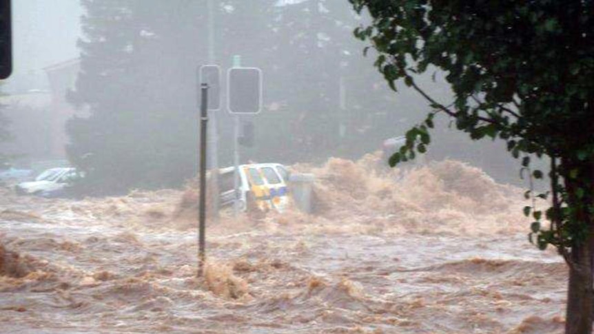 A car is engulfed by floodwaters in Toowoomba, west of Brisbane, on January 10, 2011.