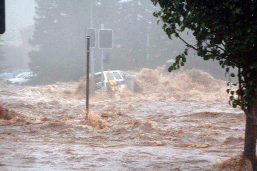 A car is engulfed by floodwaters in Toowoomba, west of Brisbane, on January 10, 2011.