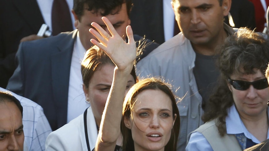 Angelina Jolie waves as she leaves a Syrian refugee camp in the southern Turkish town of Altinozu