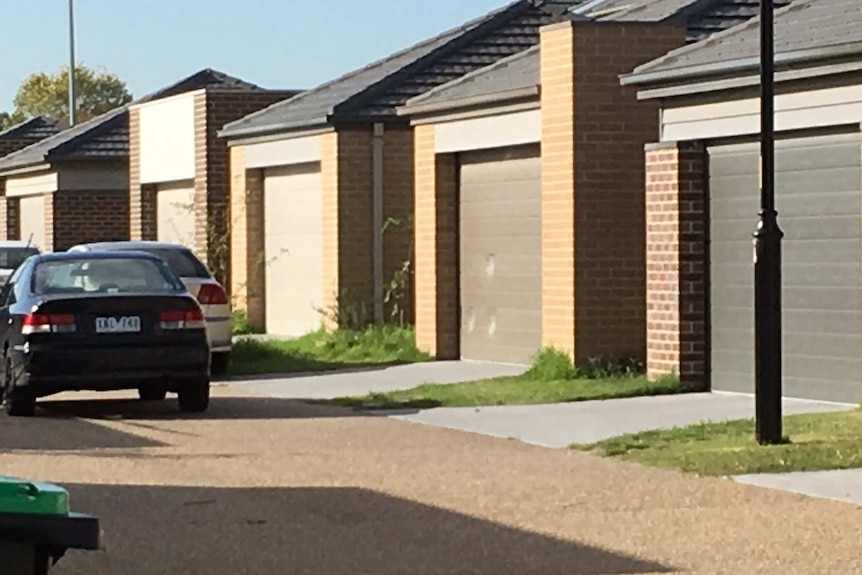 Bullet holes in the garage door of a property where three men were shot in Keysborough.