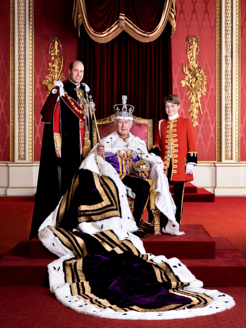 Prince William and Prince George stand either side of King Charles III as he sits on his throne at Buckingham Palace