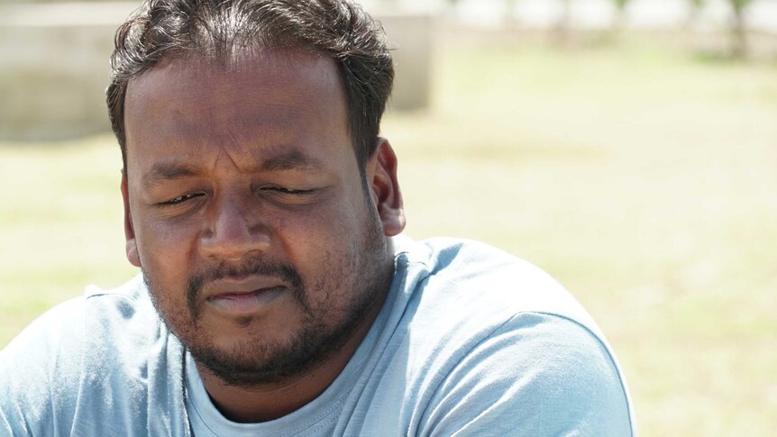 A close up of Thiru Somasuntharam, a Sri Lankan refugee in Port Moresby. He appears to be in a park.