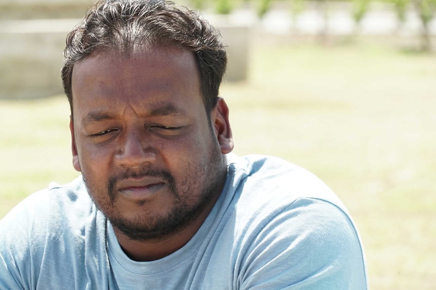 A close up of Thiru Somasuntharam, a Sri Lankan refugee in Port Moresby. He appears to be in a park.