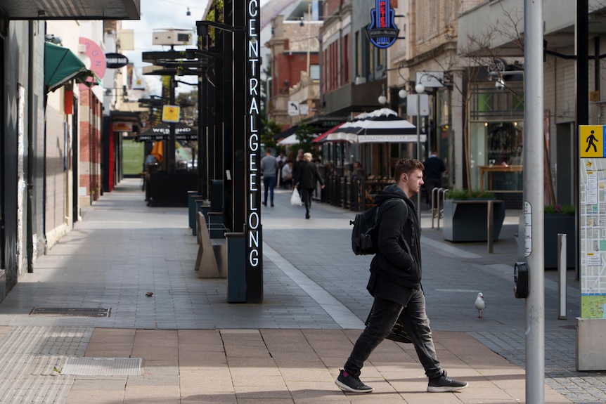A street in the Geelong CBD with a pedestrian walking past
