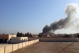 Smoke billows out of an Anbar Governorate building in Ramadi after it was hit by a mortar shell