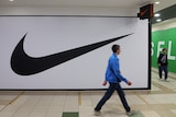 People walk past a closed store of the sporting goods retailer Nike at a shopping mall