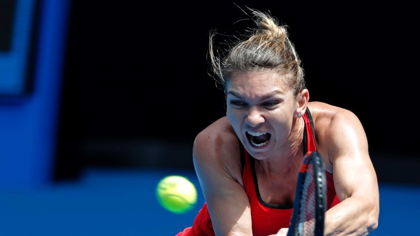 Simona Halep stretches to play a double-fisted backhand against Lauren Davis at the Australian Open.