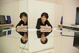 Japanese musician Cornelius looking at his reflection in a series of mirrors