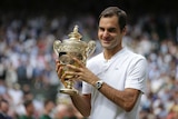 Roger Federer celebrates with the Wimbledon trophy after beating Marin Cilic in the final.