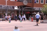 A pedestrian crossing in front of a shopping centre