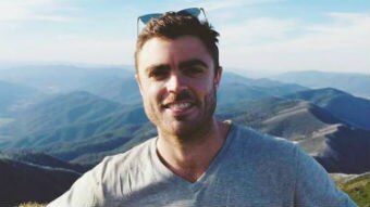 Ben Townsend poses for a photo on a mountain for a story about how loneliness helped him find his place in the world