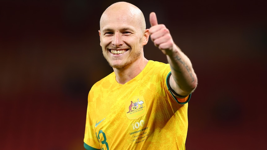 A man gives a thumbs up after winning a soccer match