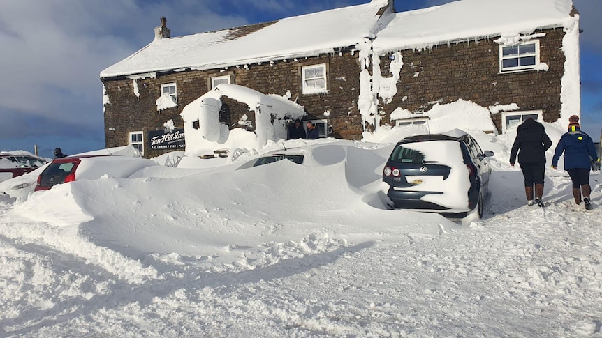 Thick snow covers the inside of a pub in England.