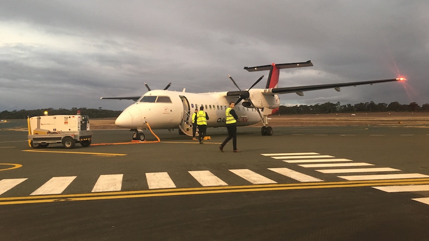 A small Qantas plane on a tarmac 