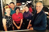 Owner of Mirrabooka McDonalds Ayman Haydar stands in the kitchen with four staff members.
