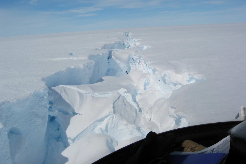A helicopter flies over the Amery ice shelf break