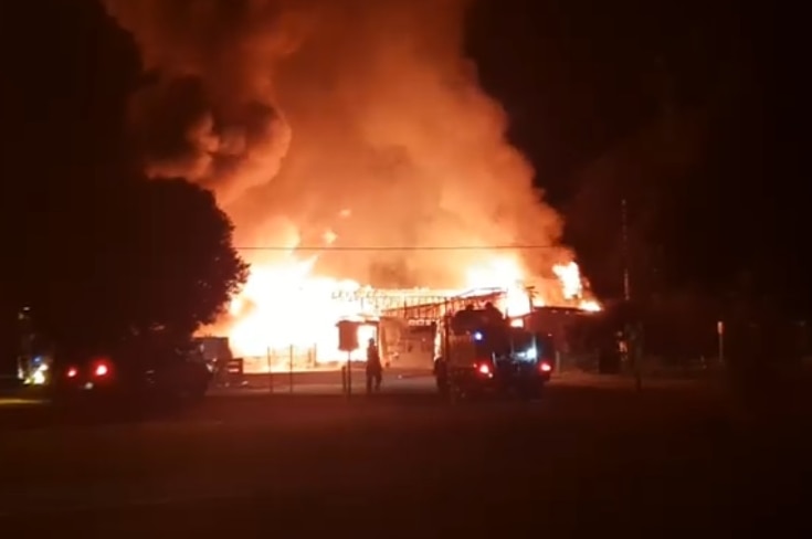 The Nangwarry Football Club is completely engulfed by flames sending clouds of smoke into the air.