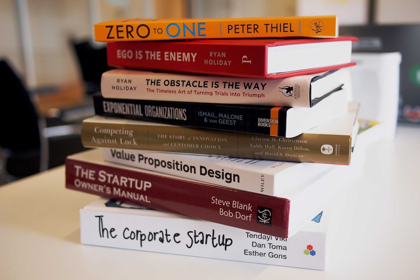 A stack of books about start-ups and which promote business success.