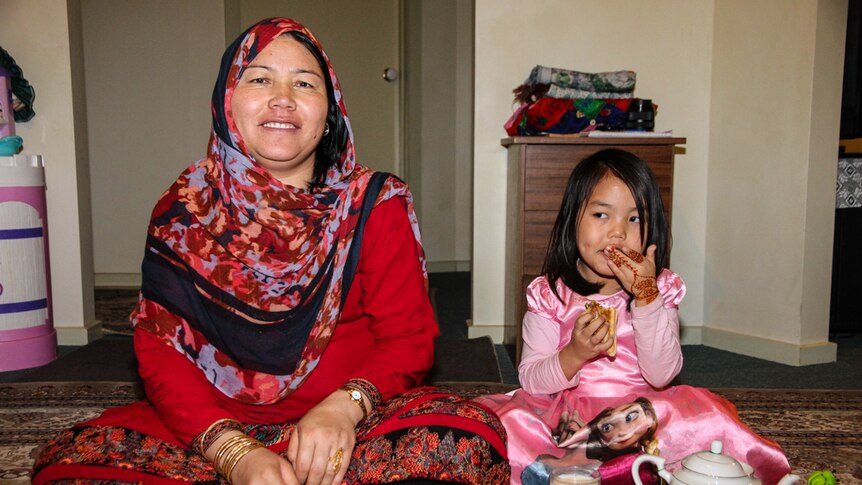 Zeba gul and her six-year-old daughter Simara gul enjoy a cup of tea and a glass of milk in their home.