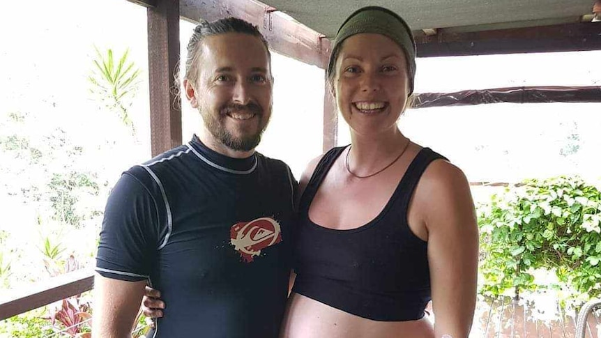 A man and woman standing on a deck