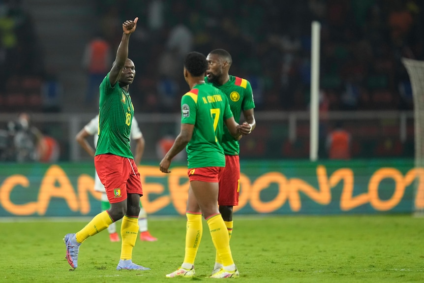 A Cameroon soccer player celebrates scoring a goal