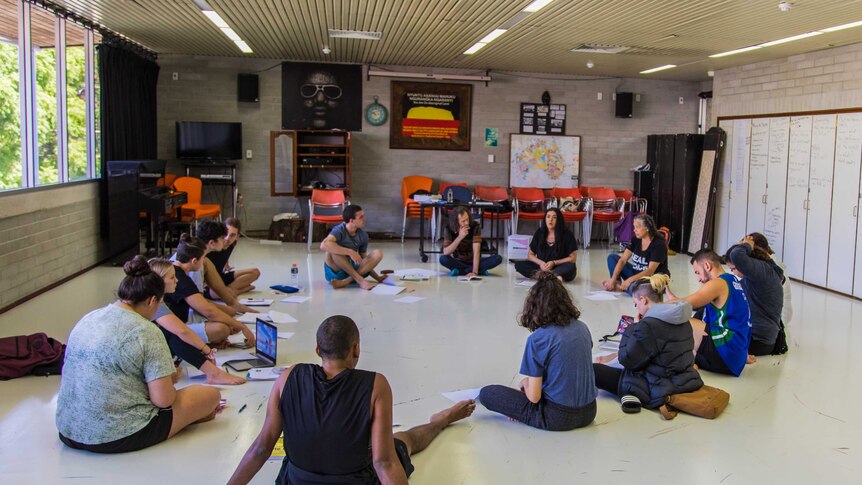 A group of Aboriginal students sit in a circle during a class