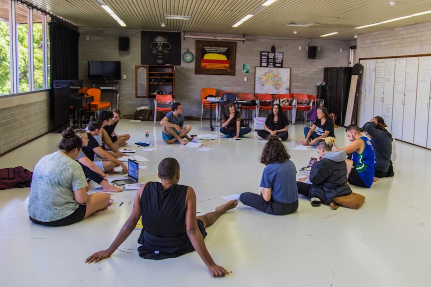 A group of Aboriginal students sit in a circle during a class