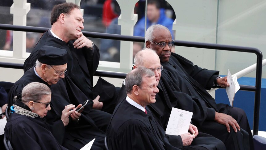 Supreme Court justices sit together at the inauguration ceremony