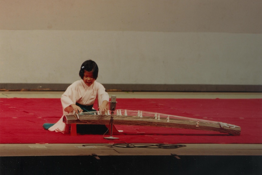Japanese child performing the Koto.