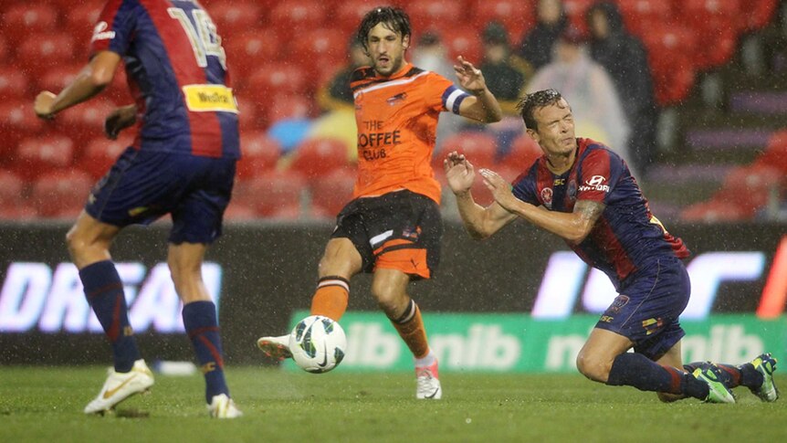 Drenched ... Thomas Broich holds off Ryan Griffiths.