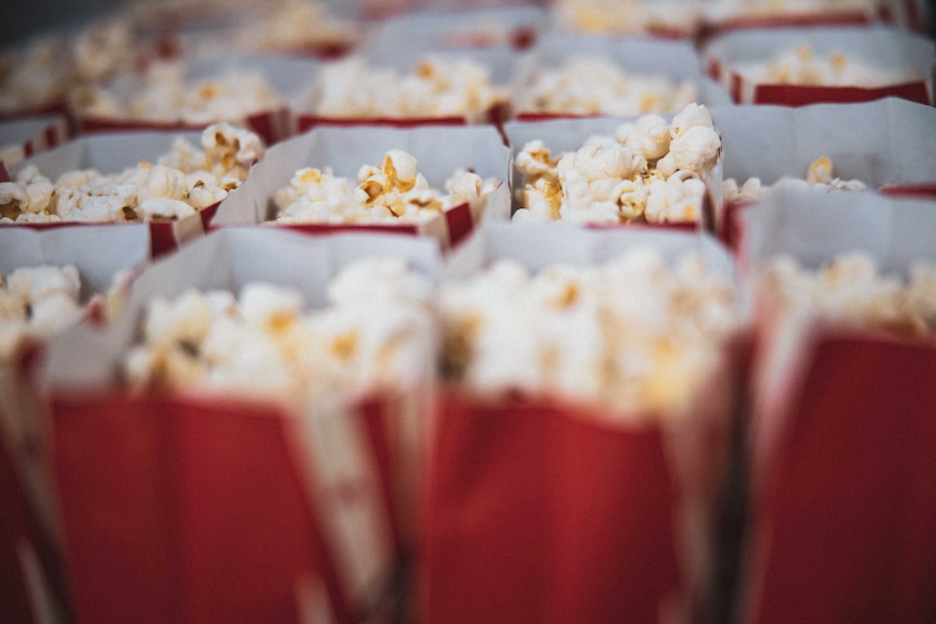 Popped corn in a red container.