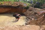 Two locals subsistence style panning for diamonds, Sierra Leone