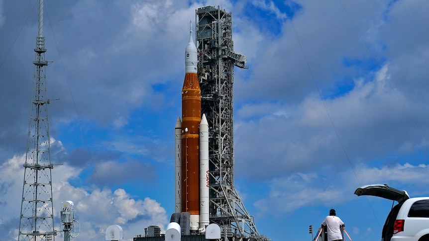 A large NASA rocket sits on a launchpad
