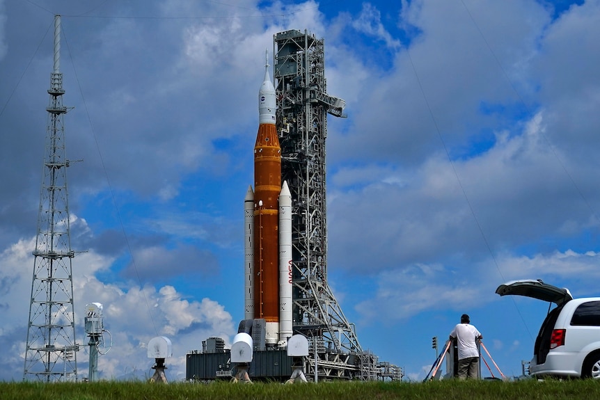 A large NASA rocket sits on a launchpad