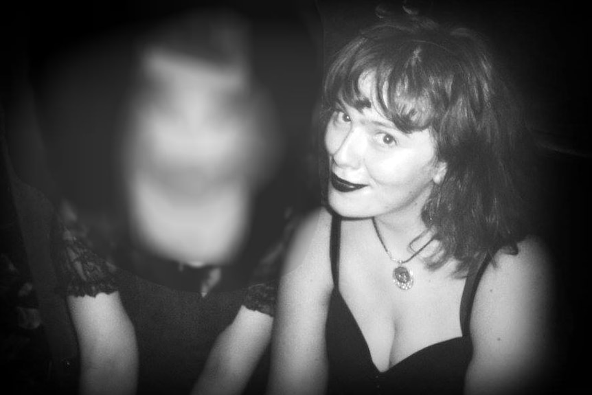 Eurydice Dixon looks at the camera as she sits with a friend out at a nightclub in Melbourne.