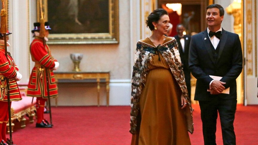 New Zealand's Prime Minister Jacinda Ardern in a long dress with her partner.
