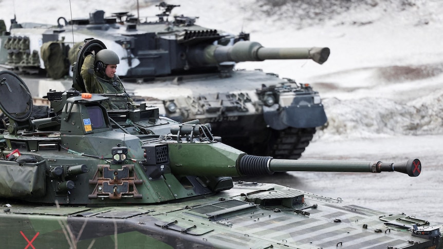 Two tanks seen in snow.