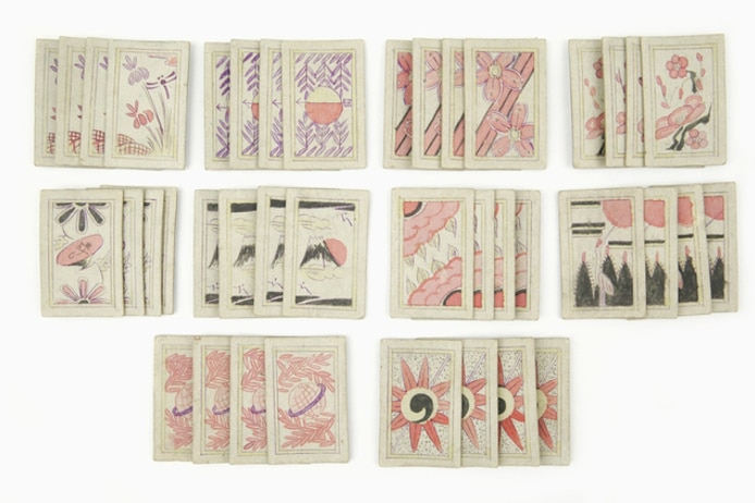 A set of playing cards decorated with images of flowers.