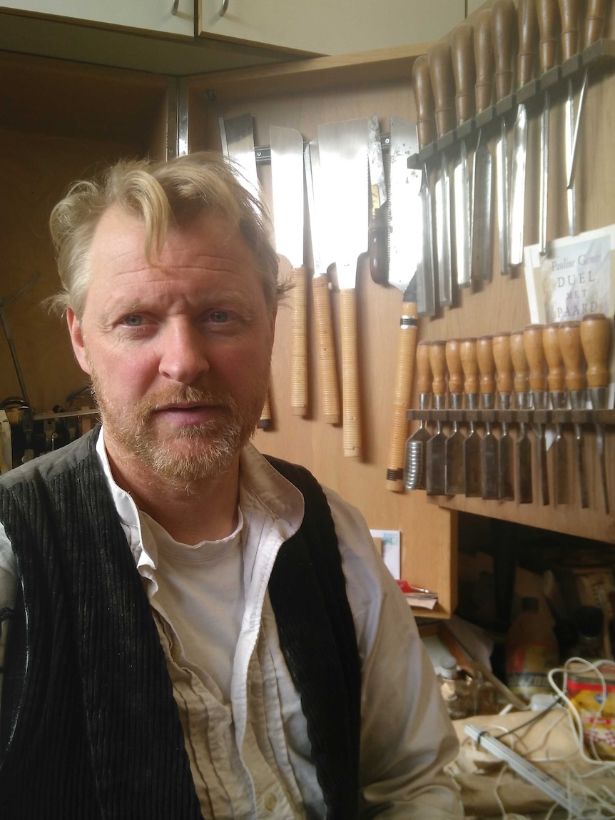 Profile shot of Christian Wolter in a carpeting workshop.