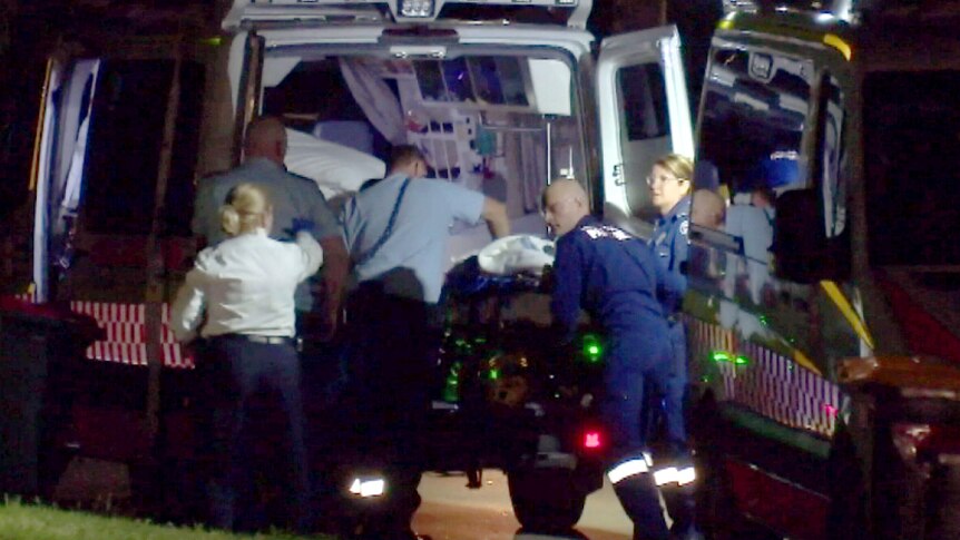 Paramedics try to resuscitate a man who was stabbed multiple times.