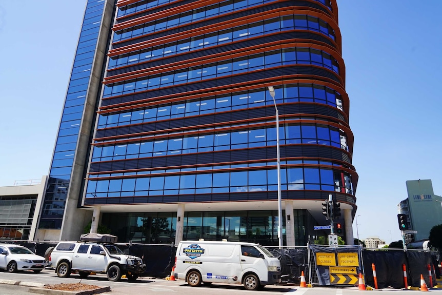 An exterior image of a glass covered building in the middle of Darwin's CBD.